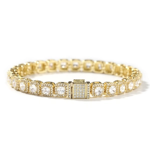 Close-up of golden tennis chain with square-cut clear zircons and iced-out square clasp