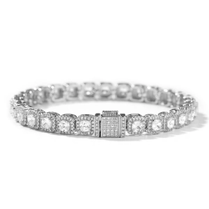 Close-up of silver tennis bracelet with square-cut cubic zirconia in halo settings