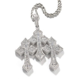 Detail of silver triple cross pendant with baguette-cut zircons on a rope chain
