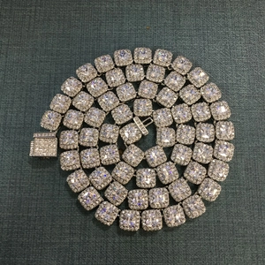 Detailed view of silver cuban chain necklace with square zircon and halo stones