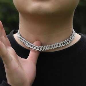 Close-up of hip hop silver Cuban link necklace with dense rhinestones on a male neck
