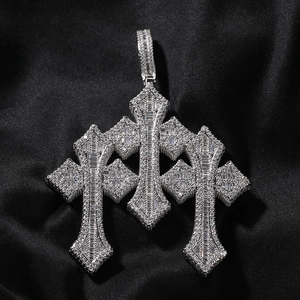 Close-up of gothic triple cross pendant with baguette and round cut diamonds on black silk