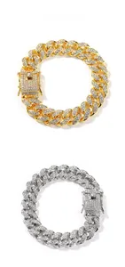 Detail of gold and silver 12mm hip hop cuban link bracelets with iced out rhinestones