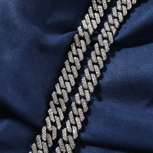 Detailed close-up of iced-out Cuban link chain with silver plating and white zircons