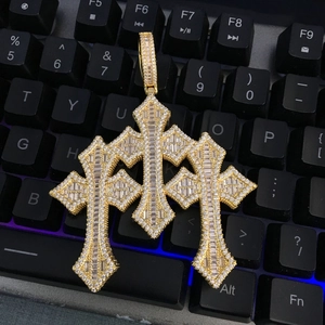 Detailed macro view of large gold-tone hip hop cross pendant with pave-set square zircon stones