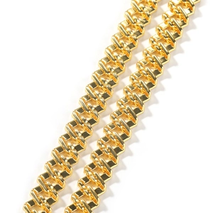 Macro shot of gold geometric link chain with polished mirror finish and hip-hop style