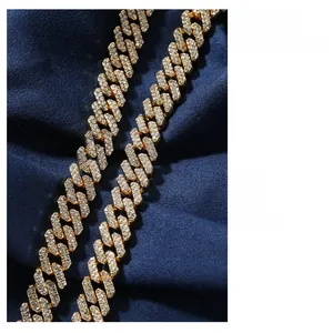 Close-up of hip hop gold Cuban link necklace with sparkling white zircons on blue velvet