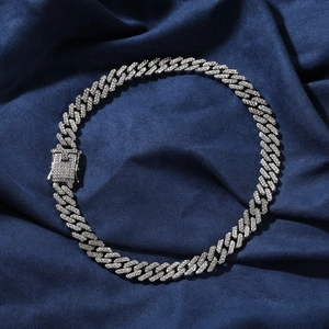 Close-up of hip hop silver Cuban link chain featuring a sparkling diamond box clasp
