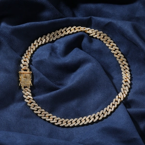 Close-up of golden iced-out Cuban chain necklace with sparkling zircon pavé detail