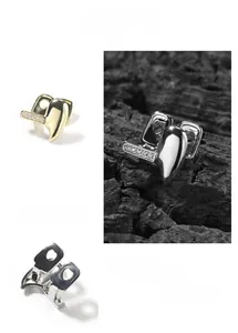 Close-up of gold and silver hip hop grillz featuring shiny rhinestones and metal curves