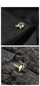 Close-up of golden hip hop single tooth grillz with sparkling micro-pave rhinestones