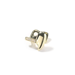 Detailed macro view of a single gold-plated hip hop grillz tooth with five sparkling rhinestones