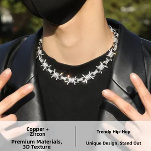 Detail of hip hop barbed wire necklace with shiny cubic zirconia in copper and silver finish