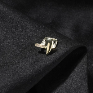 Hip hop gold single tooth grillz with cubic zirconia stones on black silk background