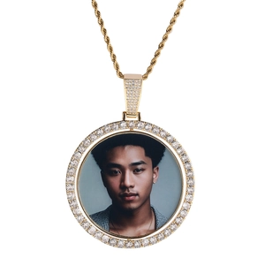 Close-up of a rotating round photo pendant with diamonds and a gold twist rope chain