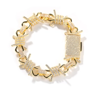 Detailed view of hip hop gold thorn link chain with encrusted white zircons and box clasp