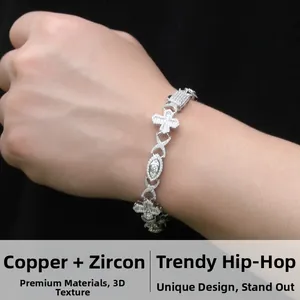 Detail of silver hip hop bracelet featuring cross and eye links set with zircons