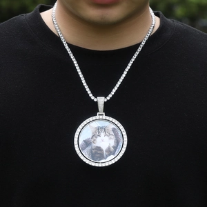 Close-up of hip-hop spinning photo pendant with iced-out tennis chain and cat picture