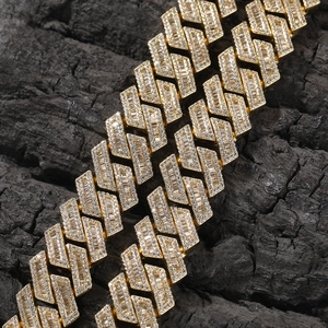 Detail of 18mm gold Cuban link chain with baguette and round cut pavé cubic zirconia