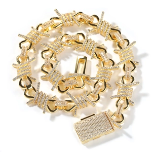 Macro detail of gold barbed wire hip hop necklace with iced out crystal rhinestones