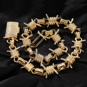 Close-up of hip hop style gold plated barbed wire chain necklace with paved zircons