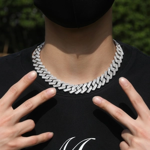 Close-up of 18mm silver Cuban link chain with paved zircon on male model in black