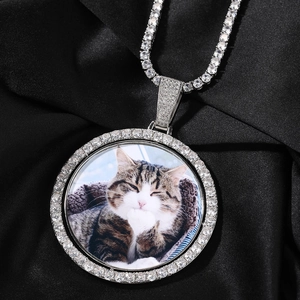 Macro view of rotating round hip hop pendant with tennis chain and pet photo
