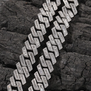 Macro detail of 18mm silver Cuban link chain with baguette cut and round zircon stones