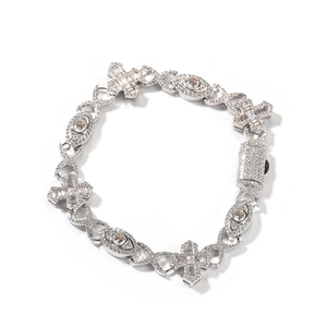 Close-up of hip hop silver bracelet with inlaid zircon cross and evil eye charm