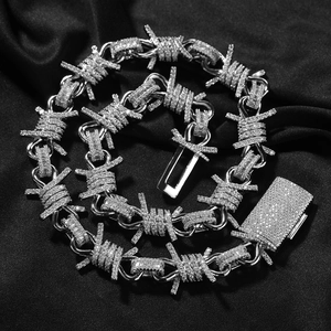 Detail of hip-hop barbed wire necklace with pavé diamonds and rectangular clasp