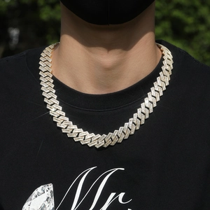 Detailed macro view of 18K gold cuban chain with paved cubic zirconia stones in hip hop style