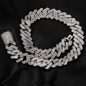 Macro detail of silver Cuban link chain featuring T-square zircons and pave round stones
