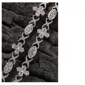 Macro shot of hip hop silver bracelet with cross and eye links set with zircons