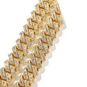 Macro shot of 18mm gold Cuban link necklace with baguette-cut zircon insets