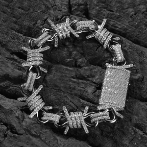 Detailed close-up of hip hop style barbed wire chain necklace with white cubic zirconia