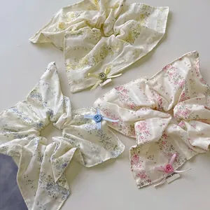 Floral scrunchies with lace bows and handmade buttons in pastel yellow blue and pink