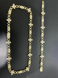 Close-up of hip-hop gold plated jewelry set with cross links and cubic zirconia