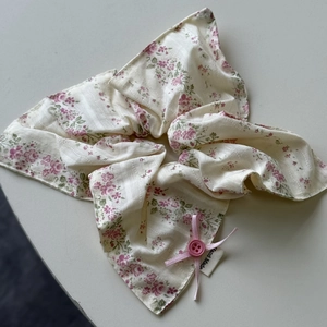 Close-up of floral scrunchie with pink bow ribbon and hand made label detail