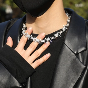 Close-up of hip-hop silver barbed wire necklace with paved rhinestones on male model