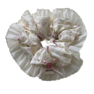 Floral chiffon scrunchie with pink bow and ruffled lace trim for bun hairstyles