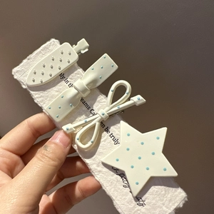 Cute four-piece hair clip set in milky blue polka dots with bow and strawberry shapes