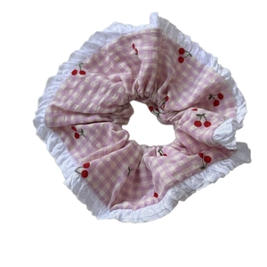 Pink checkered oversized scrunchie with red cherry patterns and white lace trim