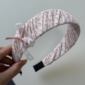Detail van roze bloemen scrunchie met witte kant en een decoratieve strik afwerking