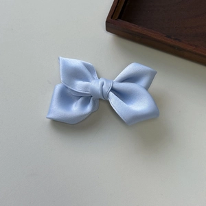 Elegant light blue satin bow hair clip for women with a smooth silk texture finish