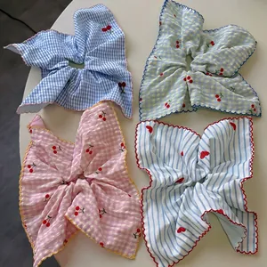 Set of four pastel plaid scrunchies with cherry embroidery and lace trim on white base