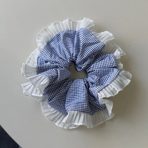 Blue and white plaid scrunchie with white pleated ruffle trim for women's hair styling