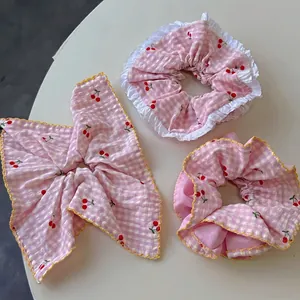 Pink plaid cherry scrunchie set with white lace edges and matching hair ribbon