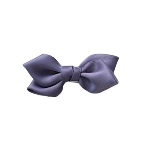 Elegant purple bow hair clip made of textured polyester ribbon on white background