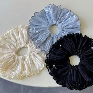 Elegant 3-piece set of pleated satin scrunchies with pearls and ribbons in beige, blue and black