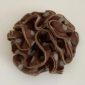 Detail of coffee brown chiffon scrunchie with blue polka dots and delicate stitched edges